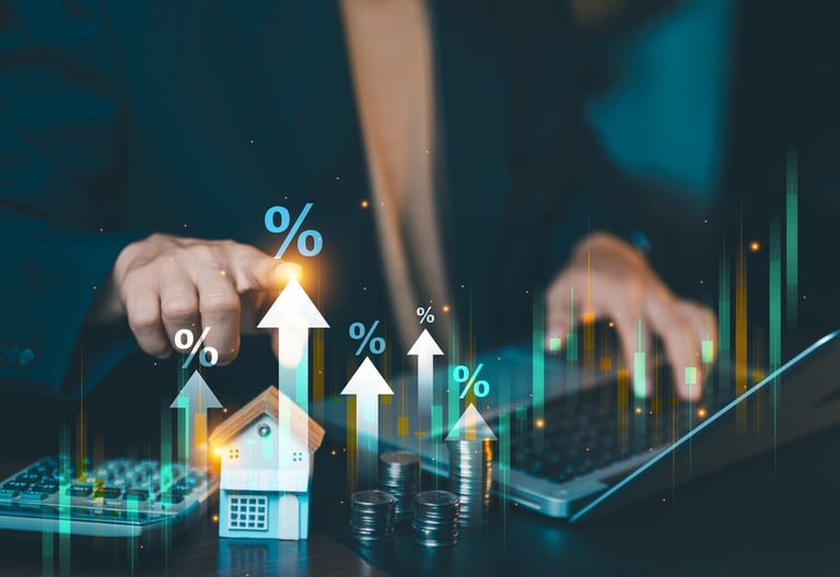 Businessman analyzing real estate market growth graph with rising interest rates percentage icon on laptop computer