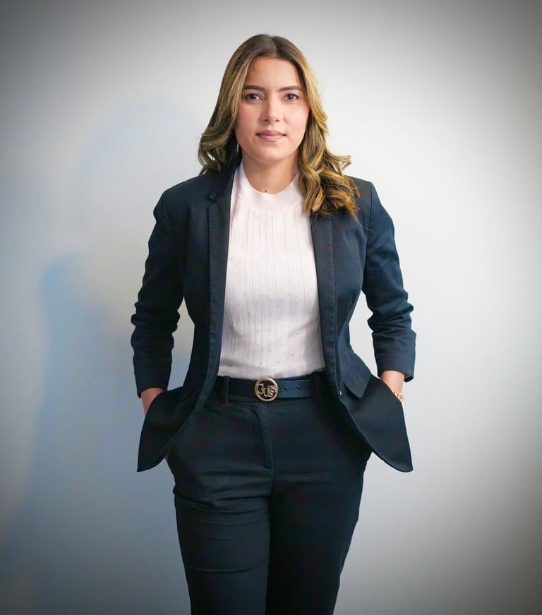 Professional woman in dark blazer and white blouse poses against neutral background